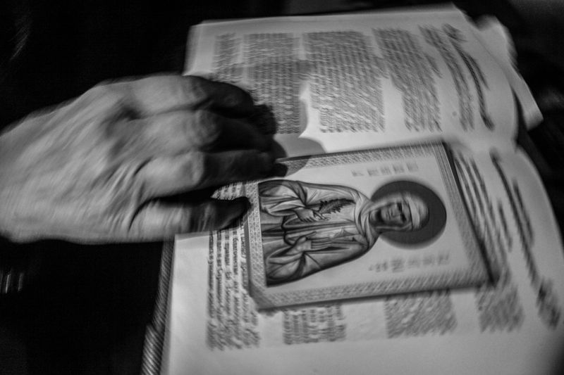 © Kuba Kaminski - Whisperer Wiera serches for a prayer in her spell book.