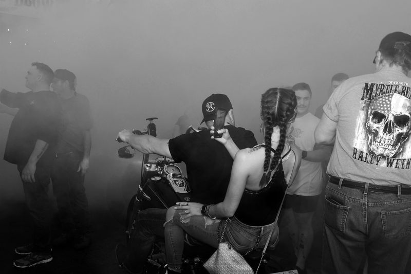 © Mary-Louise Miller - Smoke and Pigtails.  Motorcycle rally. © ML Miller