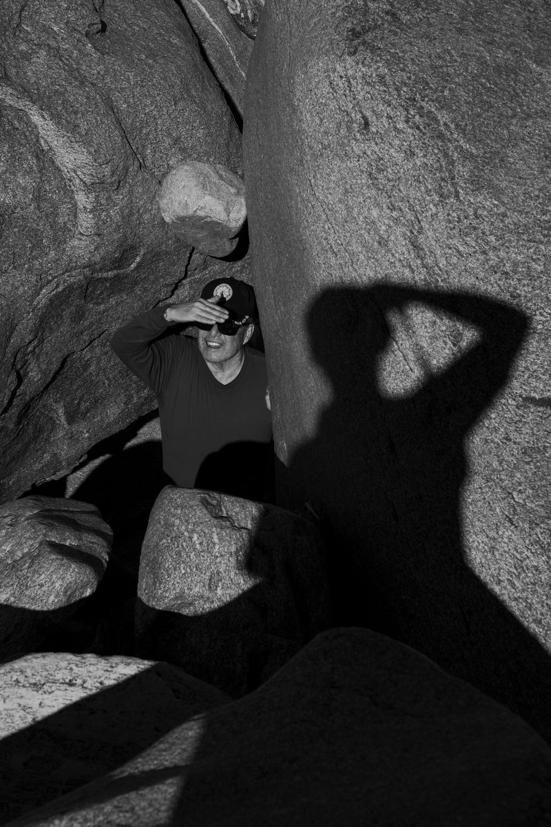 © Marcus Xavier Chormicle - My uncle looks up at the sky while my shadow falls on the rock next to him.