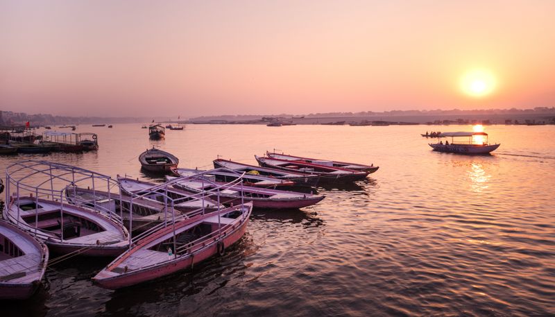 © Takshak Parmar - Boats are bathed in morning light at Varanasi ghats | Varanasi, India