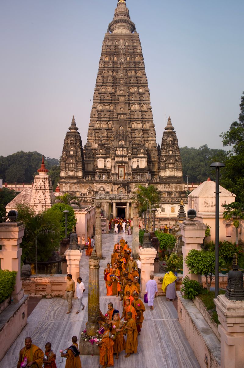 © Takshak Parmar - A line of monks with lotus flowers circumnavigating the Bodhi temple at dawn | Bodh Gaya, India