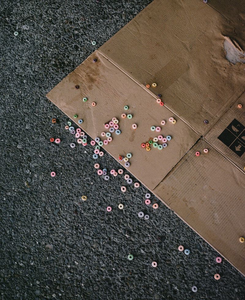 © Justin Maxon - Fruity Loops cereal is seen scattered on cardboard near where a houseless person was previously sleeping.