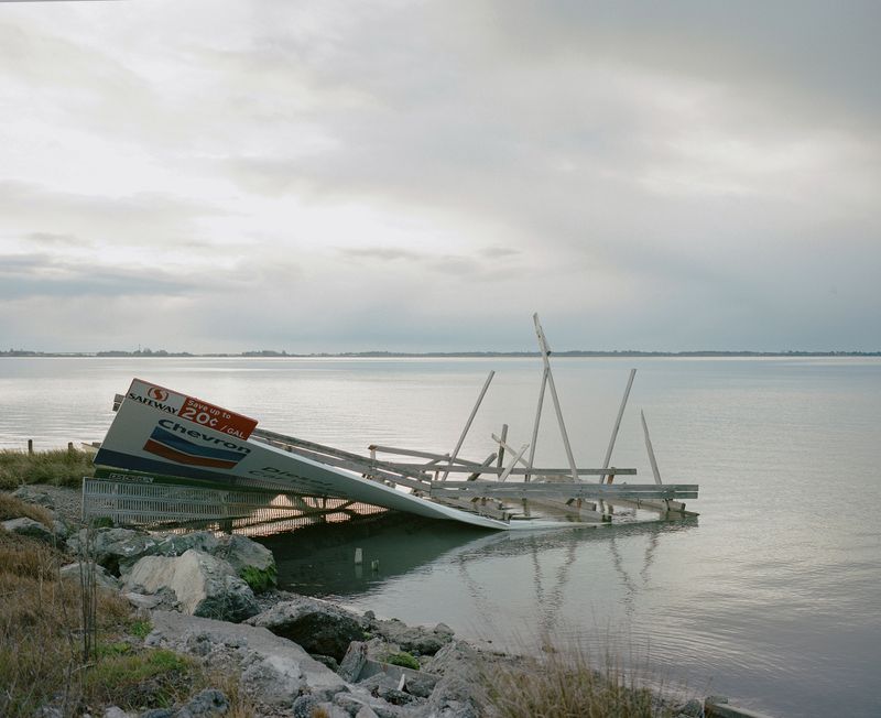 © Justin Maxon - A Chevron billboard is seen collapsed on the Humboldt Bay outside of Eureka.