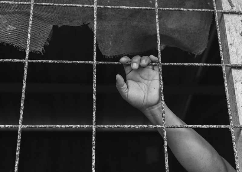 © Daniela Beltran B. - A kid's hand grabbing a fence.