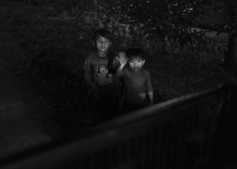 © Daniela Beltran B. - Children wave goodbye to a moving truck.