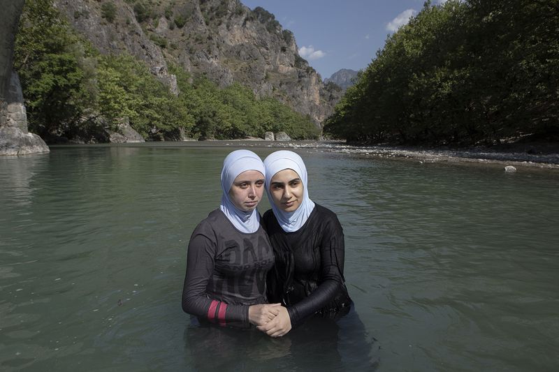 © dimitris rapakousis - Women from Syria in Aoös River, which starts from Greece and flows into the Adriatic Sea in Albania. Greek-Albanian border.