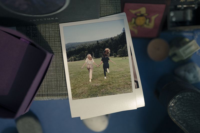 © Sitara Thalia Ambrosio - On Sasha N.'s shelf next to her bed there are Polaroid photos from the time before war.