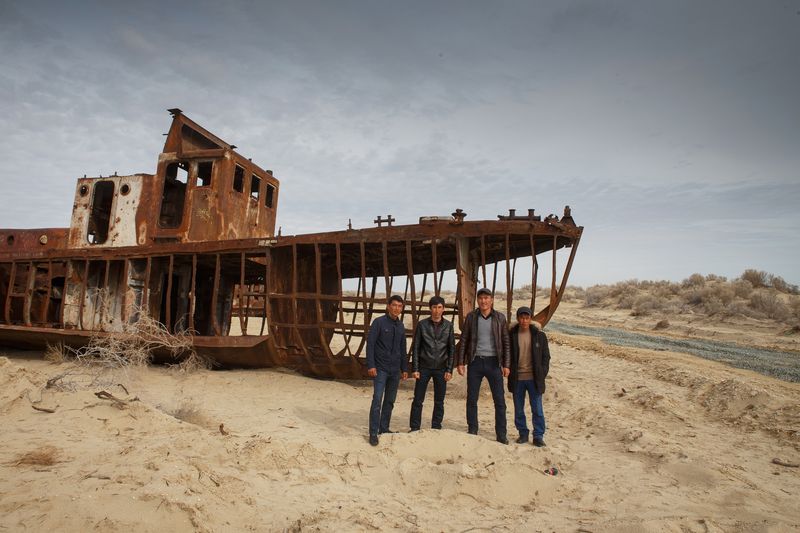 © Iulia Galushina - The skeleton of the ship and tourists in the old port of Moynaq. Moynaq, Uzbekistan.