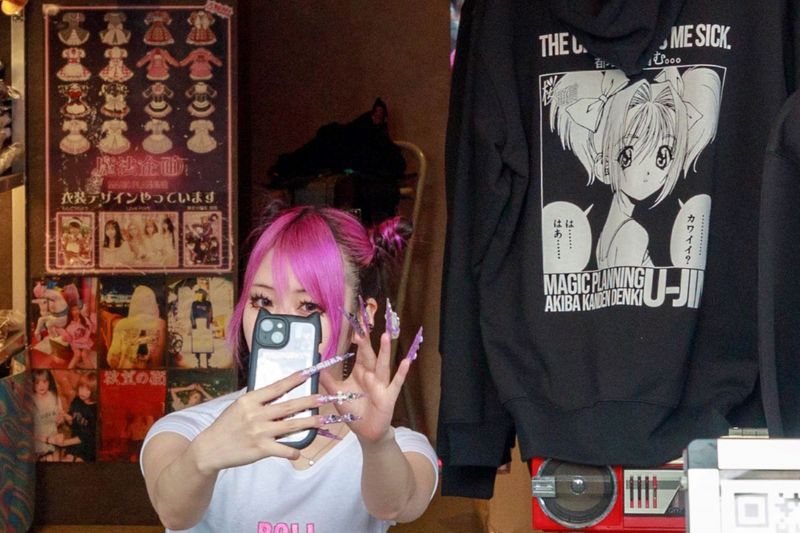 © ROBERTA LODI - "Selfie Girl with Pink Nails"      A young woman taking a selfie, her long pink nails catching the light.