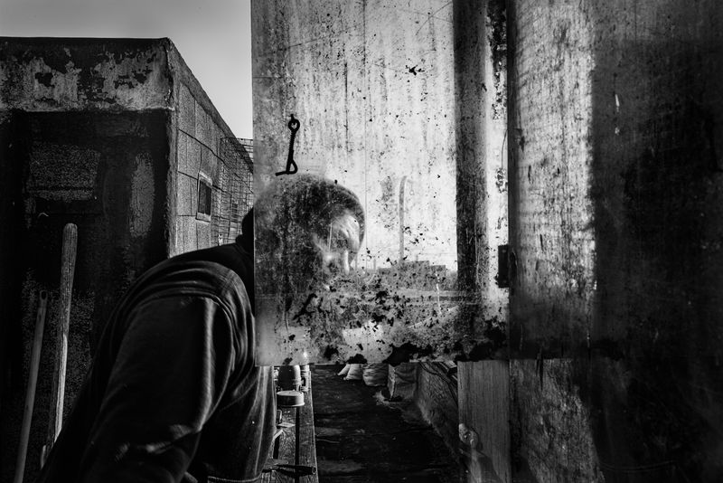 © Bastien Deschamps - Tony the “Terminator” checks on sick birds on his rooftop in Cypress Hill, Brooklyn, January 26th, 2019