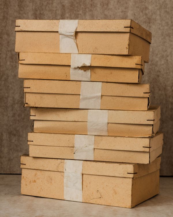 © max.korndoerfer - Pile of cartons where buttons have been stored.