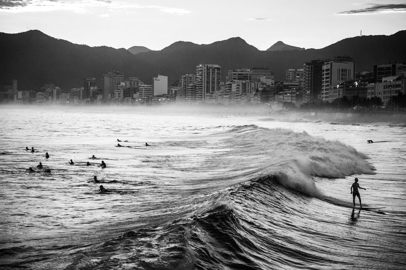 © João Pina - A man rides a wave at Arpoador beach, Ipanema, southern Rio de Janeiro. April 2016.