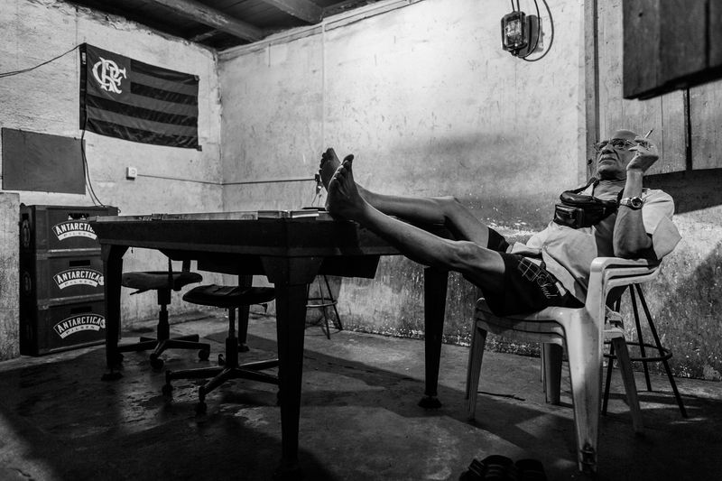 © João Pina - A man watches television in a bar in the Dona Marta favela. November 2009.