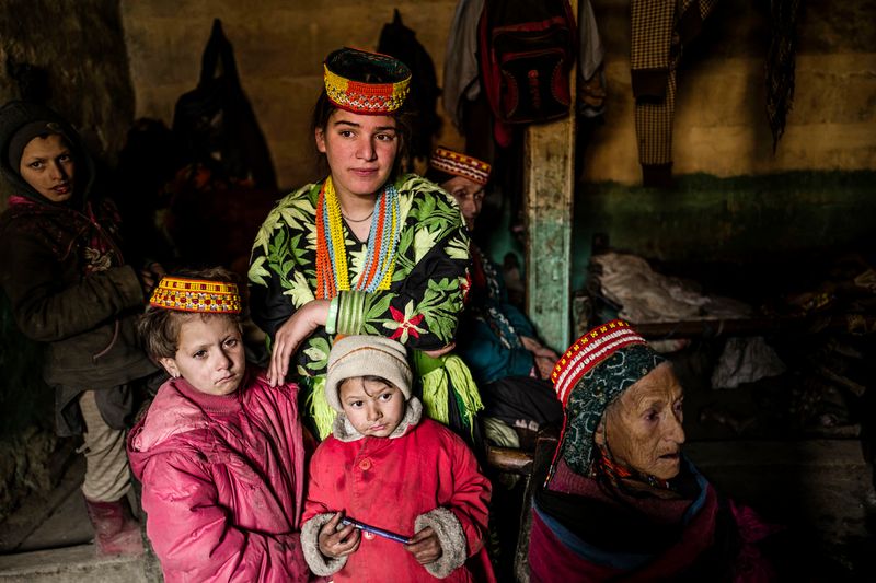 © Sarah Caron - Kalash families after sunset gather in the main room, which acts as a kitchen, dining room as well as bedroom.