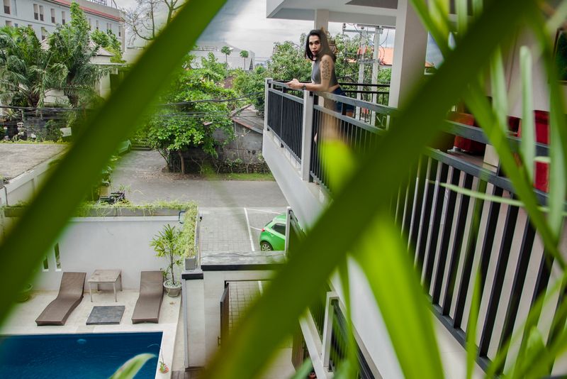 © András Polgár - Cha Cha is standing on the balcony of a hotel.