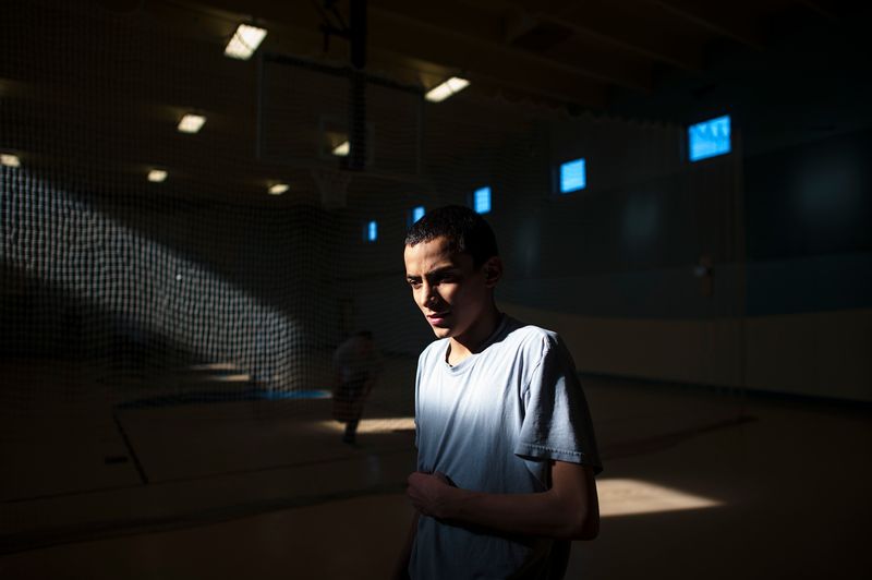 © Isadora Kosofsky. Ramon, age 15, stands in the gym at the juvenile detention center in Albuquerque, New Mexico