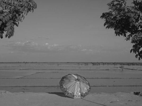 © Narayan Kaudinya, One Umbrella by the River Field, from the series Singsong, 2018