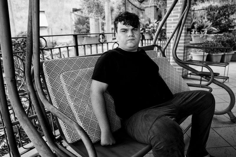© BARBARA ZANON - July 2022, Magione, Umbria: portrait of Michele (15) while he rest in the home terrace.