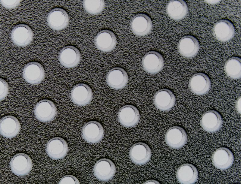 © ROGER GRASAS - Macro detail of holes in a radio headphones
