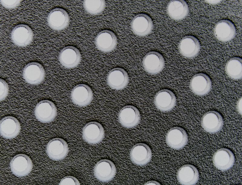© ROGER GRASAS - Macro detail of holes in a radio headphones