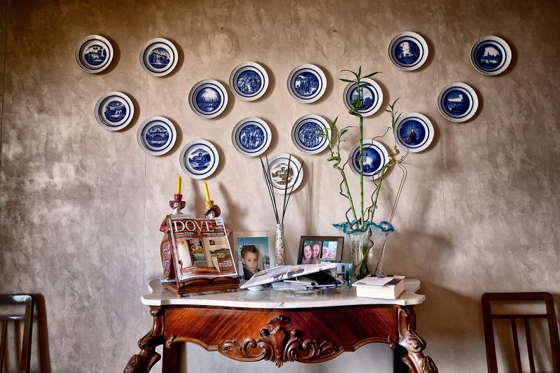 © Simona Bonanno - Living room interior with decorative plates ant family photos.