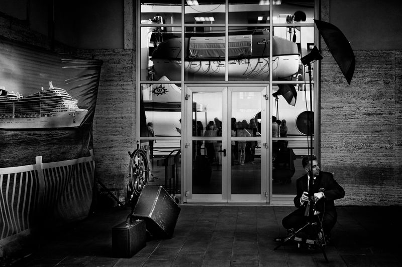 © Simona Bonanno - A photographer of the cruise ship arranging his equipment after the Embarkation photo session. Naples, Italy, 2014