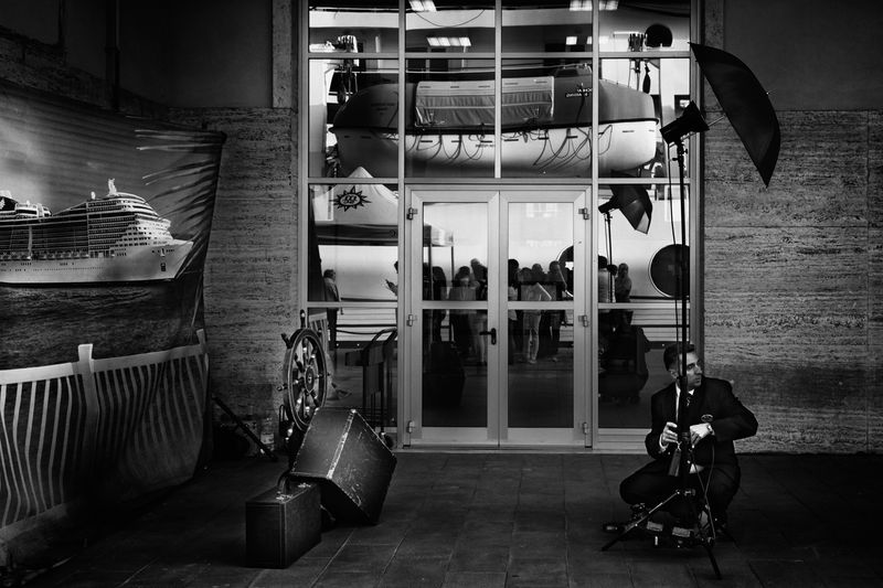 © Simona Bonanno - A photographer of the cruise ship arranging his equipment after the Embarkation photo session. Naples, Italy, 2014