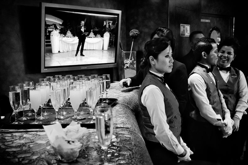 © Simona Bonanno - Waiters listening to the cruise director's speech, waiting for serving the cocktails. At sea 2015.