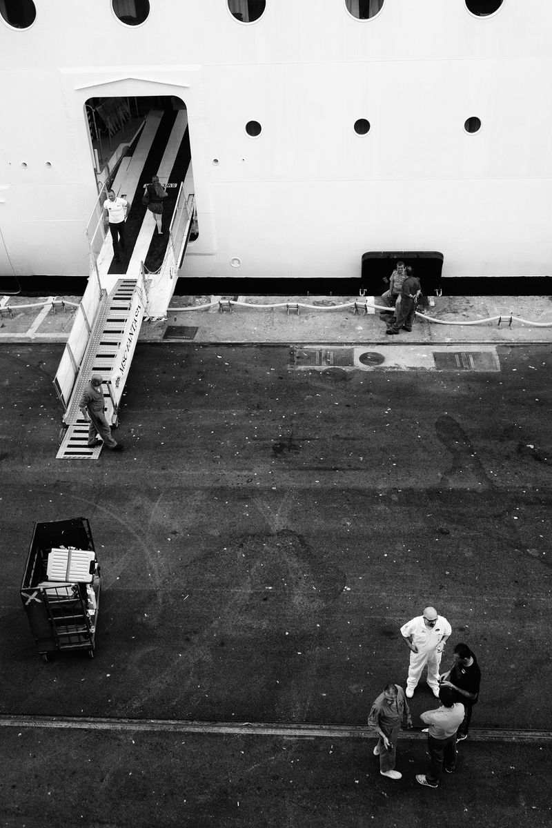 © Simona Bonanno - Crew member shaving a conversation on the dock during a break. Port of Marseille, France 2015