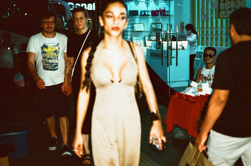 © Elizabeth Waterman - Ladyboy Maria walking to work cautiously Bangkok Thailand where Ladyboys face discrimination.