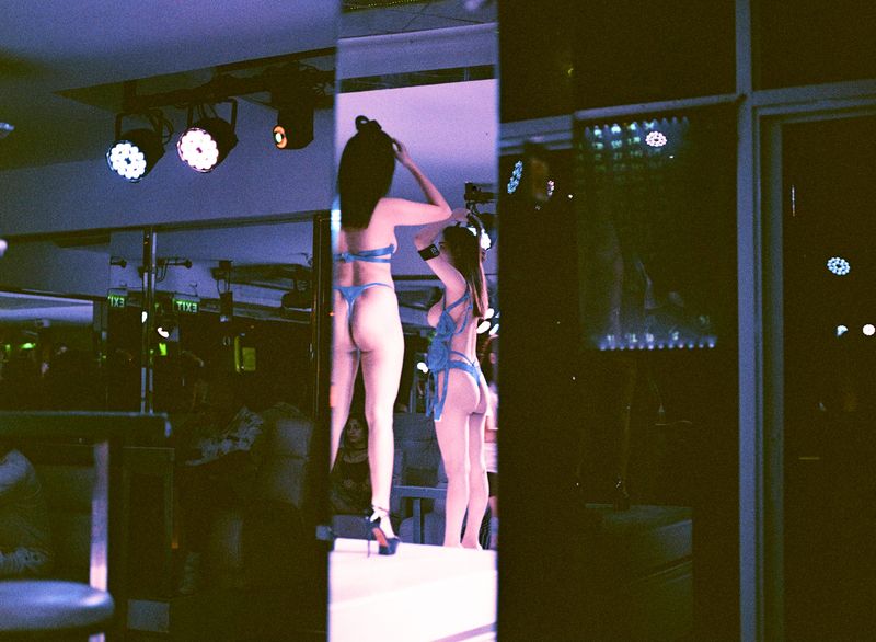 © Elizabeth Waterman - Cisgender women Gogo dancers on stage at the beginning of the night, Walking Street, Pattaya City.