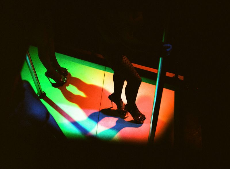 © Elizabeth Waterman - Ladyboy Chrissy dances her song set while at work in a gogo bar in Pattaya City Thailand