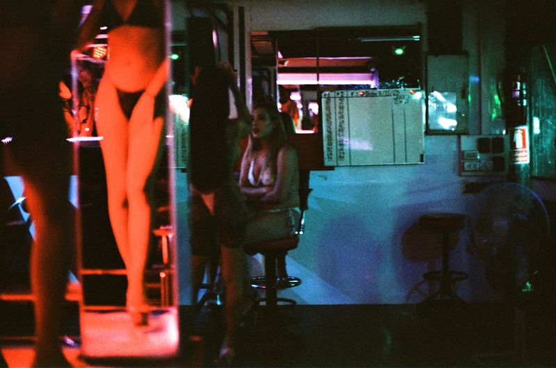 © Elizabeth Waterman - Ladyboys in Pattaya City GoGo bar, on stage and talking to one another.