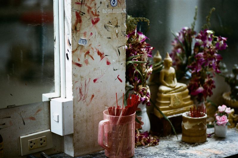 © Elizabeth Waterman - Buddhist altar in locker room at gogo bar in Pattaya City, Thailand.