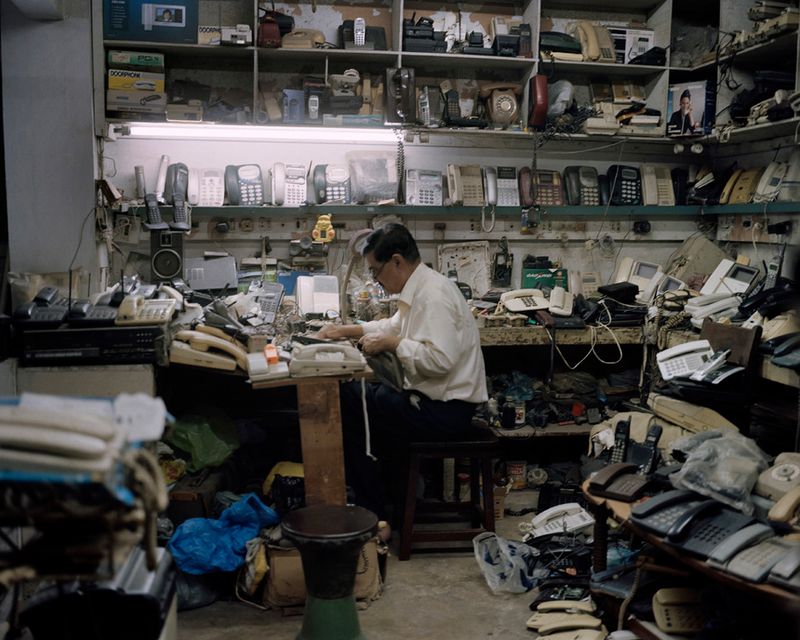 © Valentino Bellini - Karachi, Pakistan. A small repair shop specialized in electric and electronic devices inside a shopping mall .