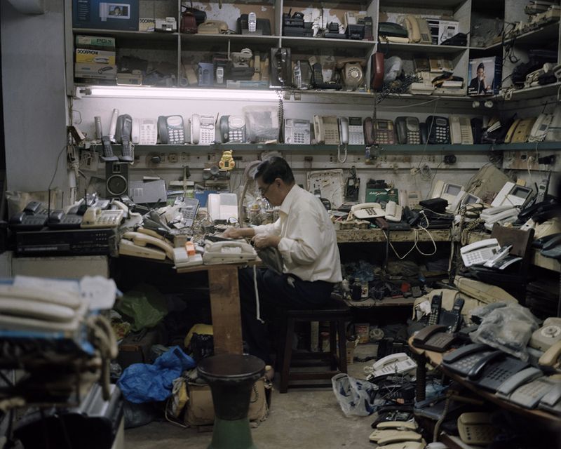 © Valentino Bellini - Karachi, Pakistan. A small repair shop specialized in electric and electronic devices inside a shopping mall .