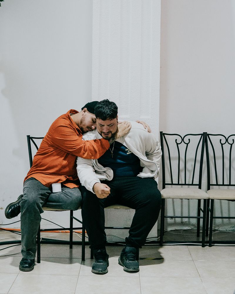 © Almendra Fantilli - A man prays for another man during an evangelical service, Santiago, Chile, 2024.