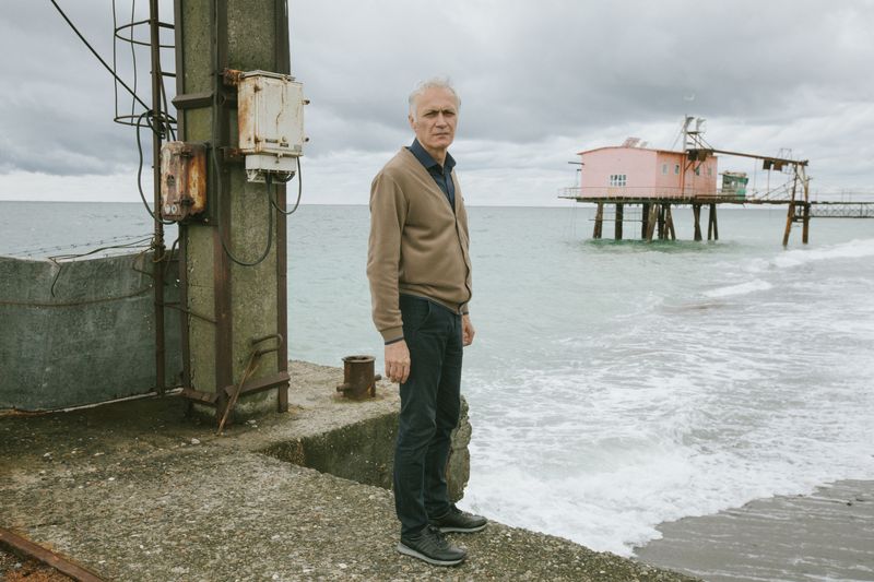 © Natalya Madilyan - Roman Dbar, Director of the Institute of Ecology of Abkhazia against the background of the sea research station.
