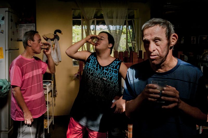 © Ilana Bar - Uncle Toninho looks at me, my brother Taere and Uncle Carlao are having coffee in the background.
