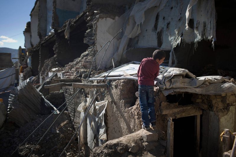 © Daniel Pilar - Refugees in a house in Kabul on march 25th 2014. The building collapsed after heavy rain.