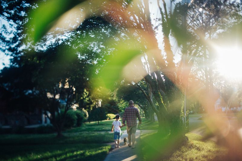 © Angela Ramsey - James holds Jay's hand as they walk Loinel Richie the dog.