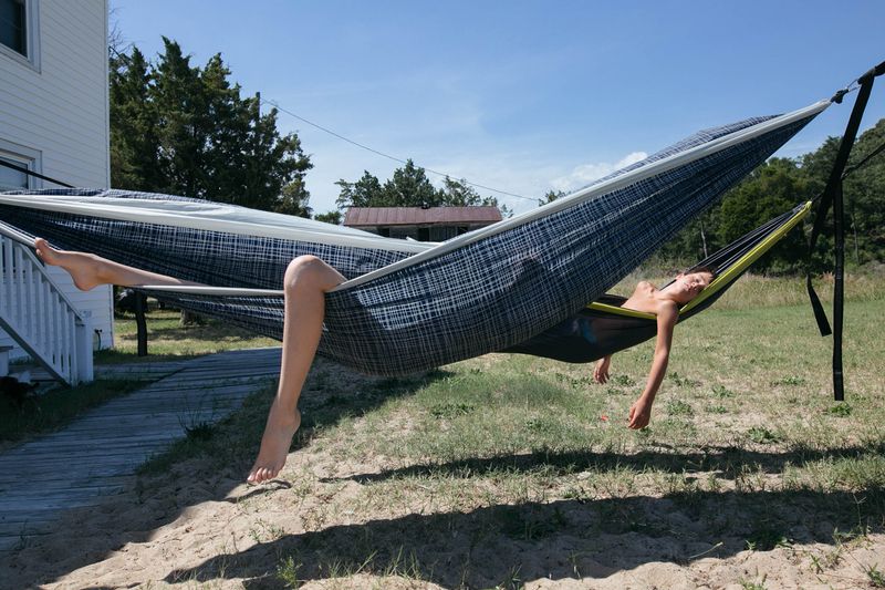 © Angela Ramsey - Two of the children nap in hammocks while on vacation.