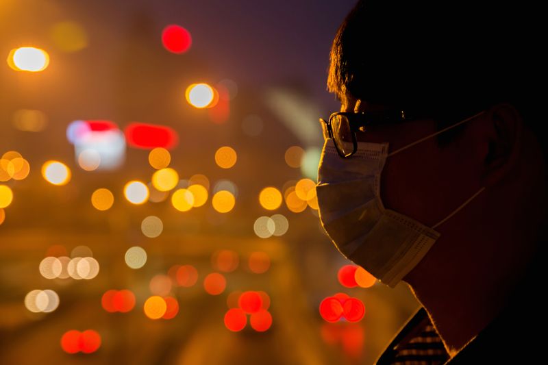 © Sean Gallagher - Zhao (25), an office worker, stands on a bridge above a busy highway in the centre of Beijing.