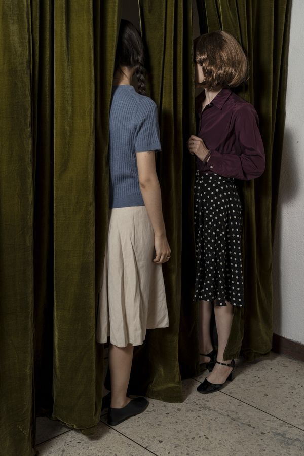 © Valeria Arendar - Behind the curtain, ordinary gestures of looking and whispering become entangled with gossip, suspicion, and paranoia.