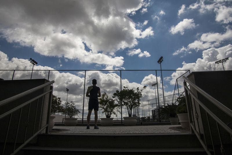 © Chiara Ferronato - A resident prepares to enter the tennis courtyard of the gated community where he lives.