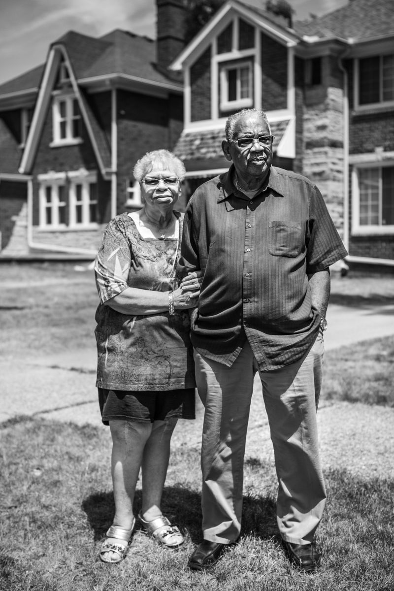 © JANICE MILHEM - Charles and wife Lillian (74 ) outside their tudor-style home in Detroit's west side.