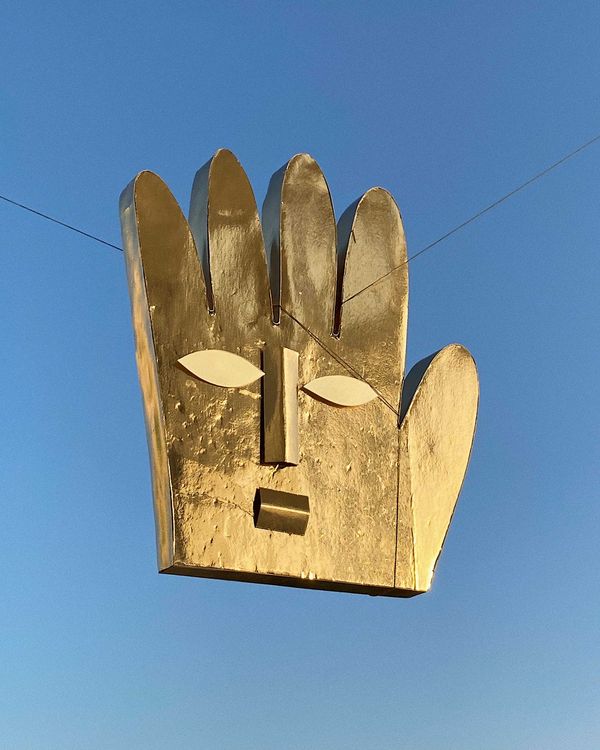 © Nikita Lukyanov - a golden hand / golden cardboard mask, cardboard was founded on the street