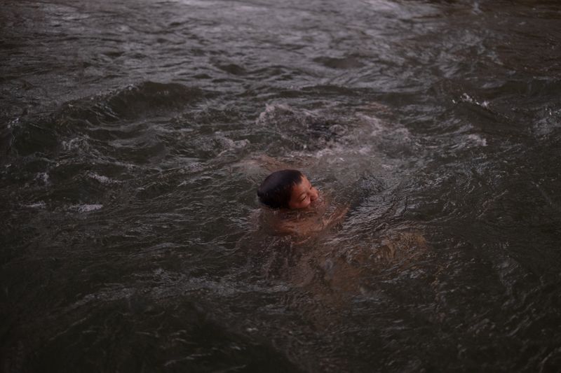 © Frédérique Gélinas - Yair playing alone in the river.