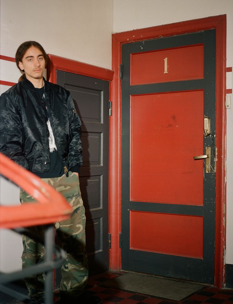© Elisa Osols - My nephew in front of the entrance doors of the apartment where my father grew up, Riga, 2024