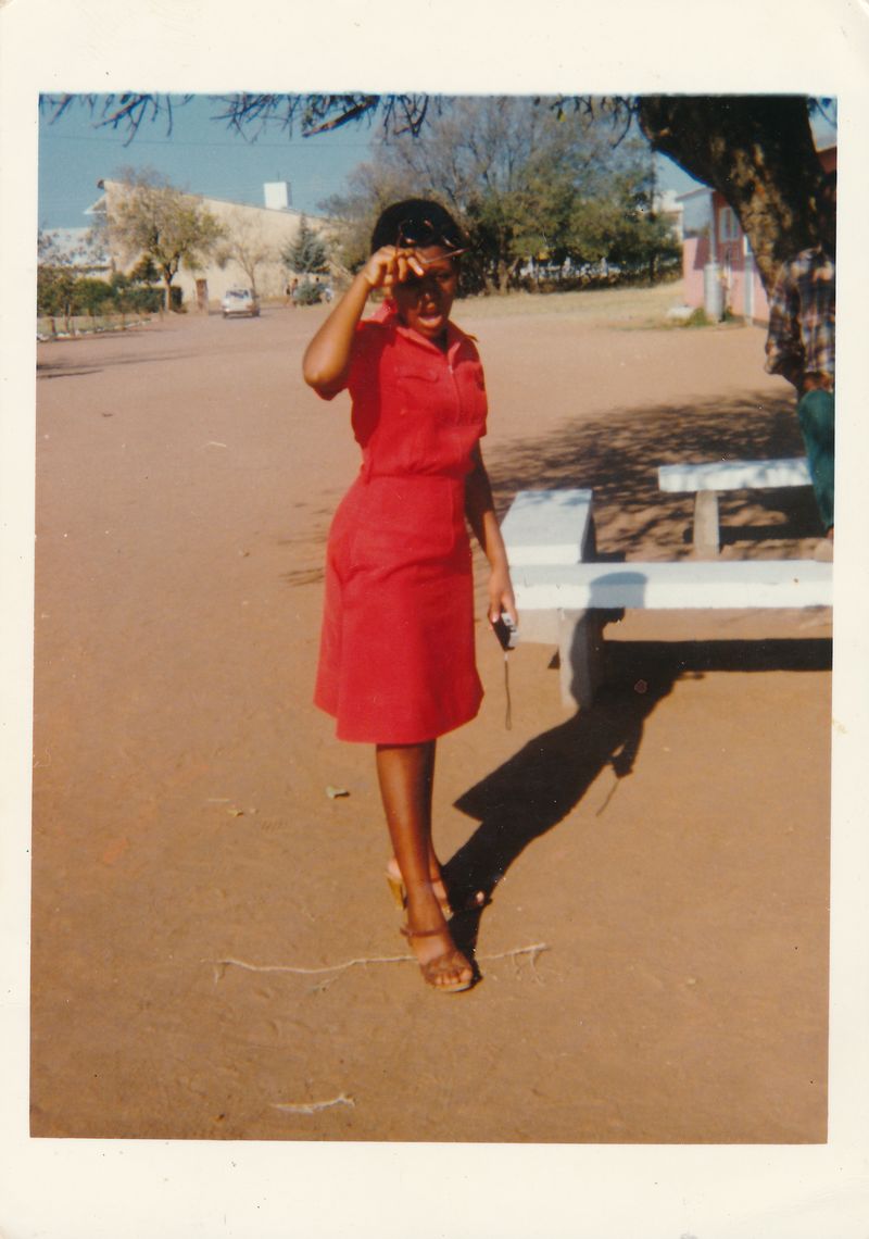 © Thero Makepe - My mother, Pinkie Mothopeng, as a teenager in the early 1980s in Gaborone, Botswana. She can be seen here holding a camera.